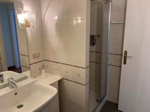 a bathroom with a sink and a shower at Palù vacanze: Cuore del centro storico in Aosta
