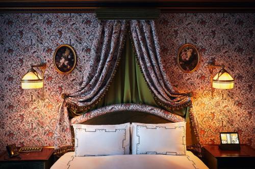 a bedroom with a bed with a canopy and curtains at L'Escape Hotel in Seoul