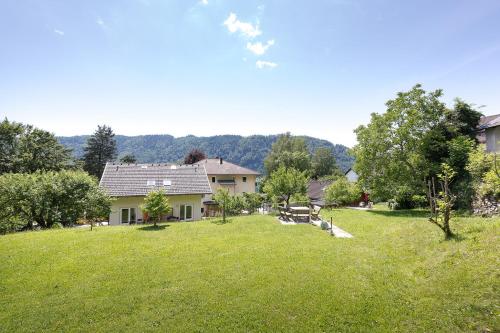 a house in a field with a grass yard at Villa Marienhof in Annenheim