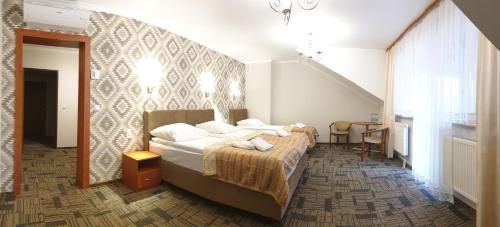 Tempat tidur dalam kamar di Hotel Kamiza