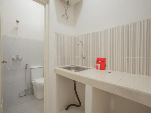 a bathroom with a sink and a toilet at RedDoorz near Ciputra Golf Surabaya in Surabaya