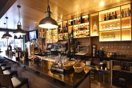 a bar in a restaurant with a lot of bottles at DWO Urban Granada in Granada