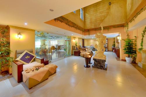 a living room with a couch and a fireplace at Fivitel Boutique Da Nang in Da Nang