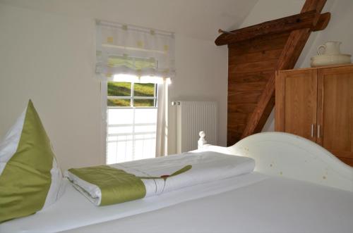 a white bed in a room with a window at Gasthof zur Post in Schmallenberg