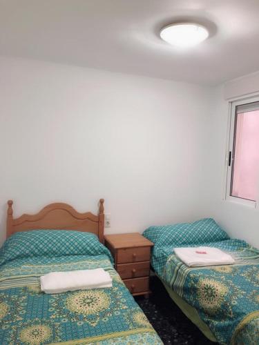 two beds sitting next to each other in a bedroom at Avenida de Daniel Gil 72 - 2º - 7ª in Ontinyent