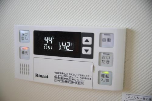 a close up of an electronic device on a wall at Guesthouse Omihachiman in Omihachiman