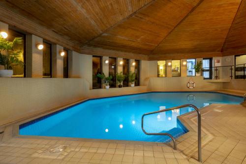 a large swimming pool with a wooden ceiling at Bridgewood Manor Hotel & Spa in Chatham