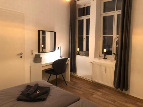 a bedroom with a bed and a desk with a chair at Ferienwohnung am Schlosspfad No. 2 in Quedlinburg