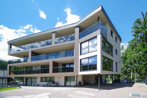 an image of a building with a blue sky at Apartment Hotel Christine in Avelengo