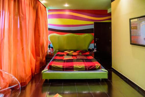 a chair in a room with a colorful wall at Diplomat Plaza Hotel & Resort in Lukovit