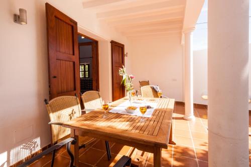 una sala da pranzo con tavolo e sedie in legno di can vinyeta a San Jose de sa Talaia