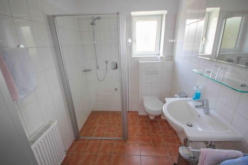 a bathroom with a shower and a toilet and a sink at Hotel Sonnenhof - bed & breakfast & appartements in Innsbruck