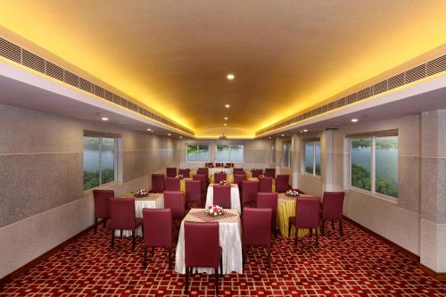 a conference room with tables and chairs in it at JVK Park Hotel in Cochin