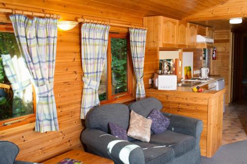 a living room with a couch in a cabin at Churchwood Valley in Plymouth