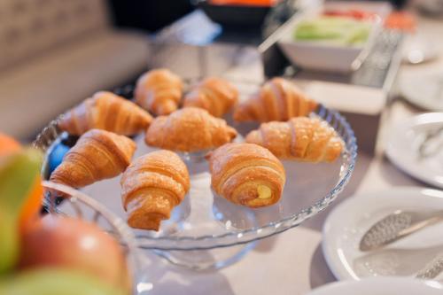 a plate of croissants and other pastries on a table at Hotel Meridian in Cluj-Napoca