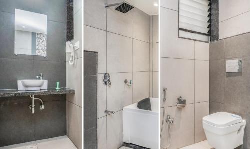 a bathroom with a shower and a toilet and a sink at Shri Vitthal Mangalam Satara in Satara