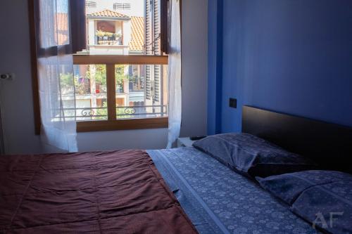 a bedroom with a bed and a window at Corso San Gottardo - Darsena Flat in Milan
