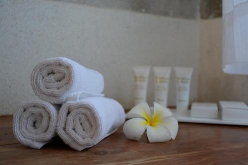 a pile of towels and flowers on a table at Amani Residence Beverly Suites in Malindi