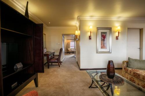a living room with a couch and a table at Cresta President Hotel in Gaborone
