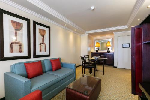 a living room with a blue couch and a table at Cresta President Hotel in Gaborone