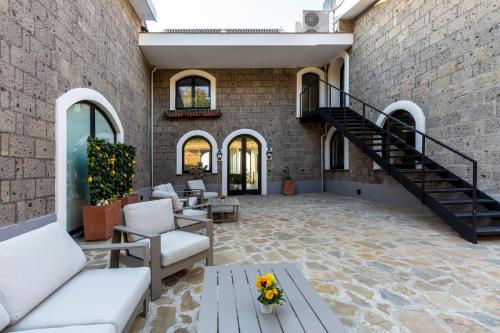 a living room with a staircase and a brick wall at Maison Bon Bon in Sorrento