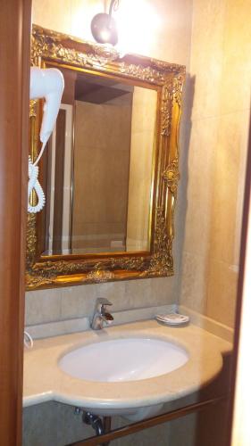 a bathroom with a sink and a mirror at Albergo Della Corte in Benevento