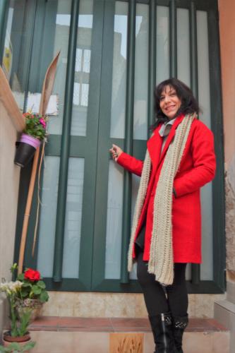 a woman wearing a red coat and a scarf at Profumo di Zagara in Lentini