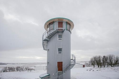 a control tower with a staircase in the snow at Klettar Tower Iceland in Fludir