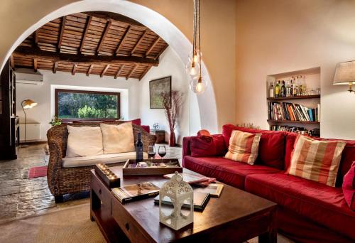 a living room with a red couch and a table at Monte do Serrado De Baixo in Évora