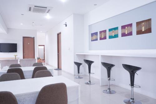 a meeting room with chairs and a white table at Mk House Tendean in Jakarta