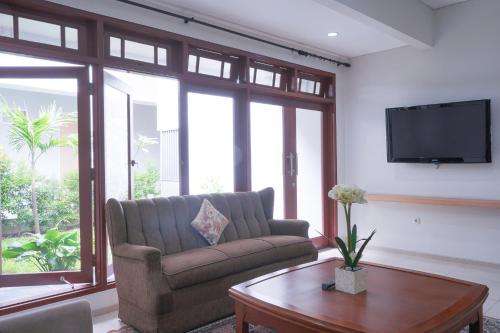 a living room with a couch and a coffee table at Mk House Tendean in Jakarta