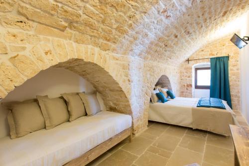 Postel nebo postele na pokoji v ubytování Masseria Castelluzzo