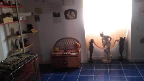 a room with a crib and three figurines on the wall at Appartamento in Carloforte