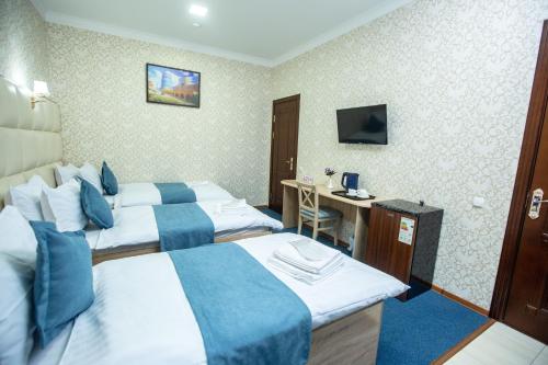 Ένα ή περισσότερα κρεβάτια σε δωμάτιο στο Mirzo Boutique Hotel