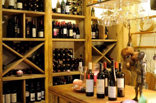 a room filled with lots of bottles of wine at Boutique Hotel Diana in Madonna di Campiglio