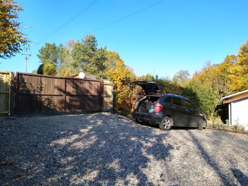 a car parked in a driveway with its door open at Birchy Hills in Sitno