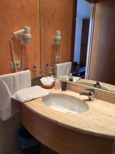 a bathroom with a sink and a mirror at Belvedere Hotel & Villa in Toscolano Maderno