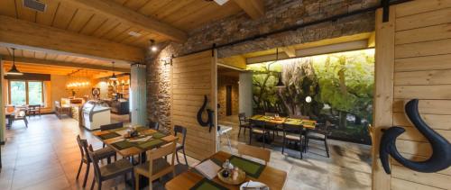 a dining room with tables and chairs in a house at Restaurace a penzion Pod Lipami Metylovice in Metylovice