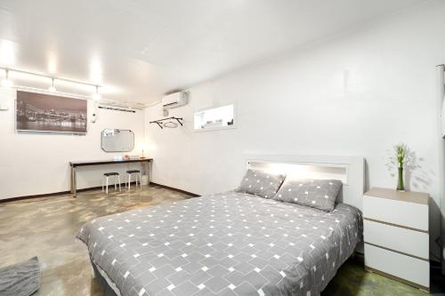 Ένα ή περισσότερα κρεβάτια σε δωμάτιο στο Jun Guesthouse