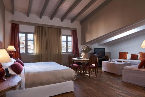 A bed or beds in a room at Emporikon Athens Hotel