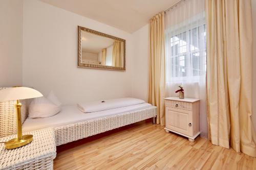 a small room with a bed and a window at Ferienwohnungen - Seehaus Riessersee in Garmisch-Partenkirchen