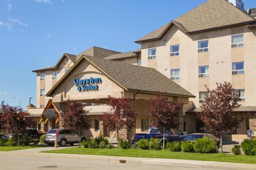 a building with a sign for adqin and mills at Days Inn & Suites by Wyndham West Edmonton in Edmonton