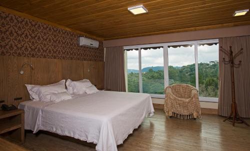 Ένα ή περισσότερα κρεβάτια σε δωμάτιο στο Villa Bella Hotel & SPA Gramado