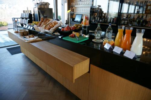 a bar with a buffet of food and drinks at GLANDON Rooms Elite in Biel
