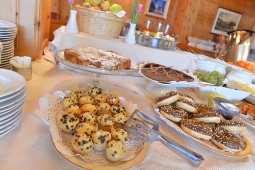 a table with two plates of pastries and other foods at Hotel Posta in Livigno