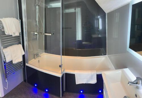 a bathroom with a shower and a sink at Luccombe Hall Hotel in Shanklin