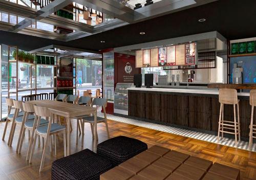 a restaurant with a table and chairs and a bar at Hotel Estelar Miraflores in Lima