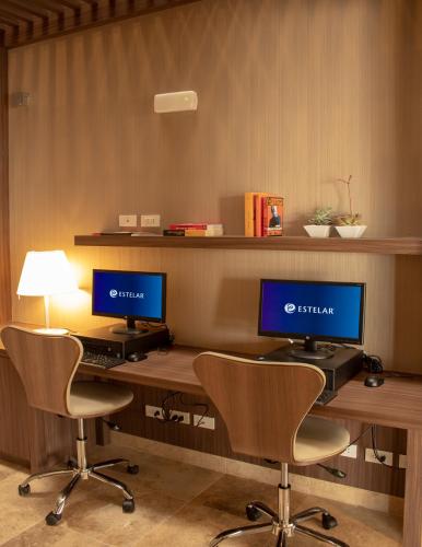 an office with two desks with two monitors on them at Hotel Estelar San Isidro in Lima