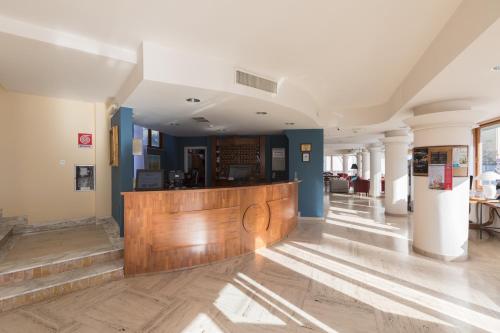 a lobby with a bar in a building at Hotel La Baia in Bari