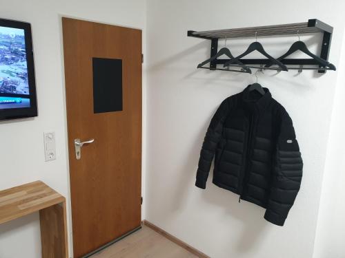 a coat hanging on a wall next to a door at Pension Pommernweg Ibbenbüren in Ibbenbüren